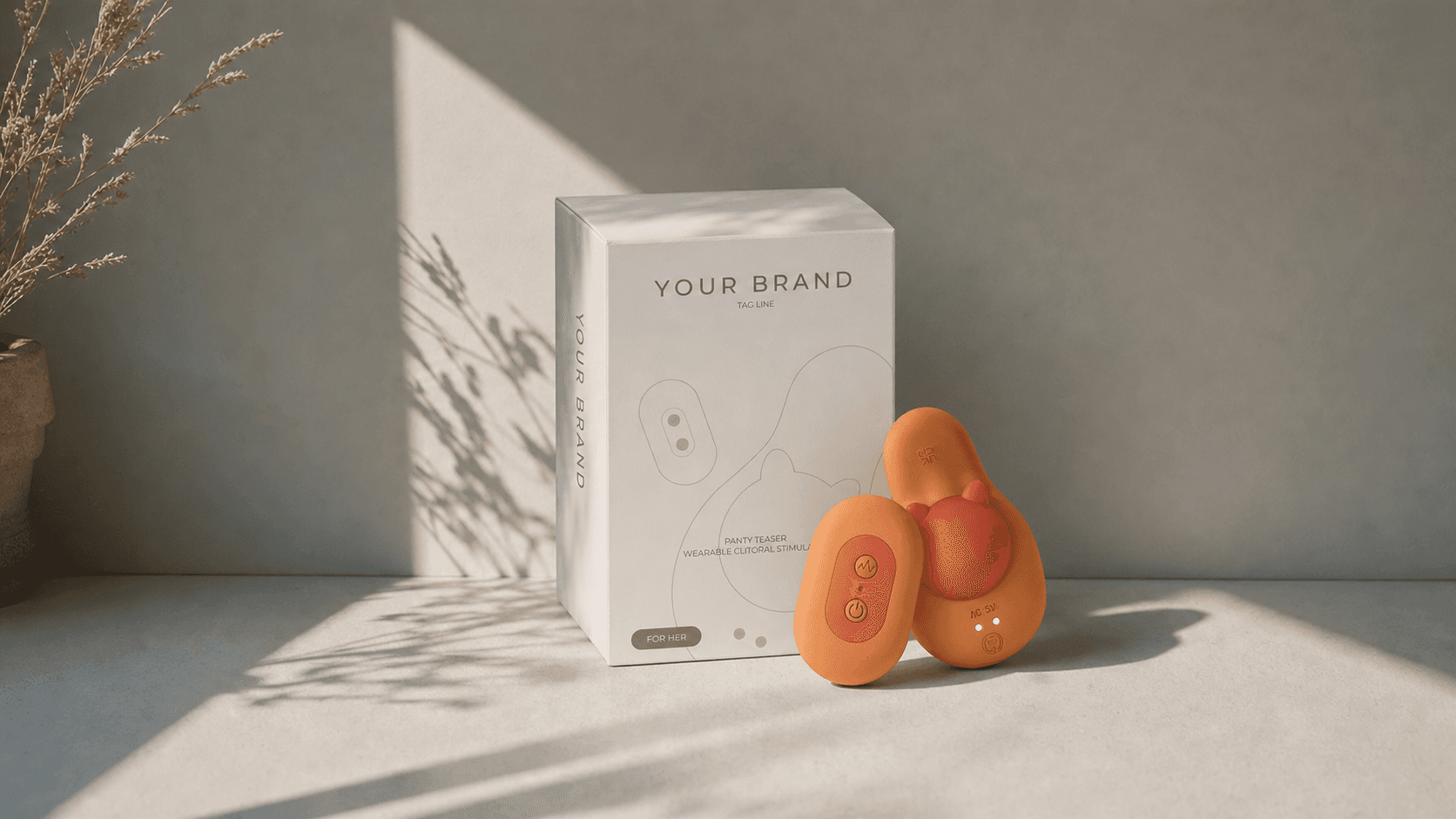 A white-label box printed with a brand name, beside two coral devices in soft daylight